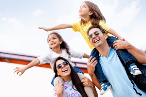 Happy family going on holidays and traveling by airplane