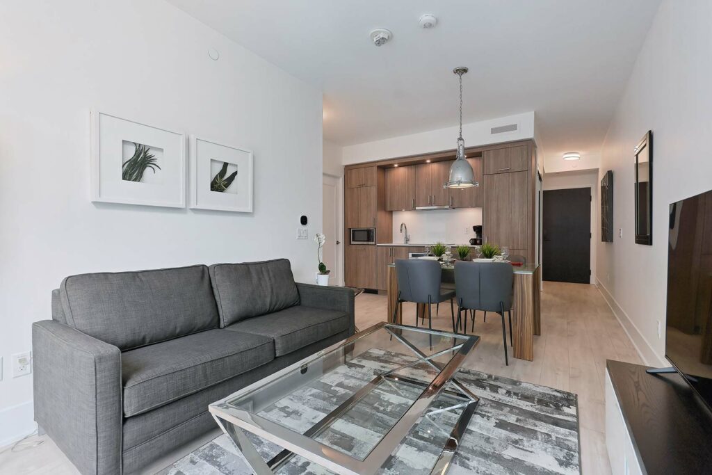 Living and dining room area of a suite at The Well