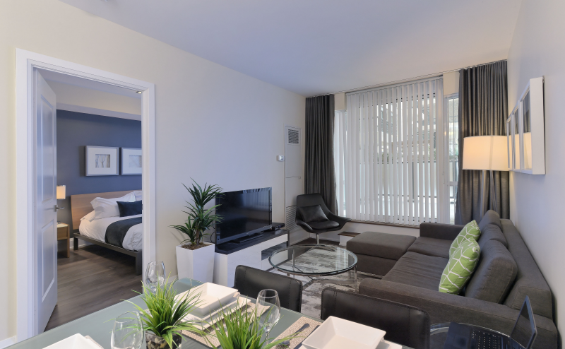 Cozy living room space with view of the bedroom.