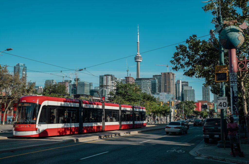 A Toronto streetcar with a view of the CN tower in the background