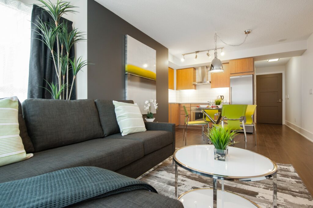 A warm living-dining-kitchen space in an apartment.