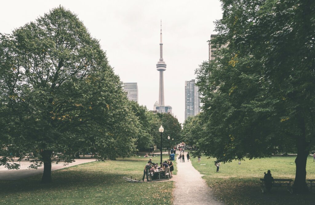 View of the CN tower from a green city park.